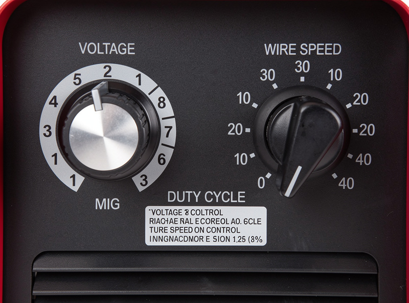 MIG welder control panel with voltage and wire speed dials