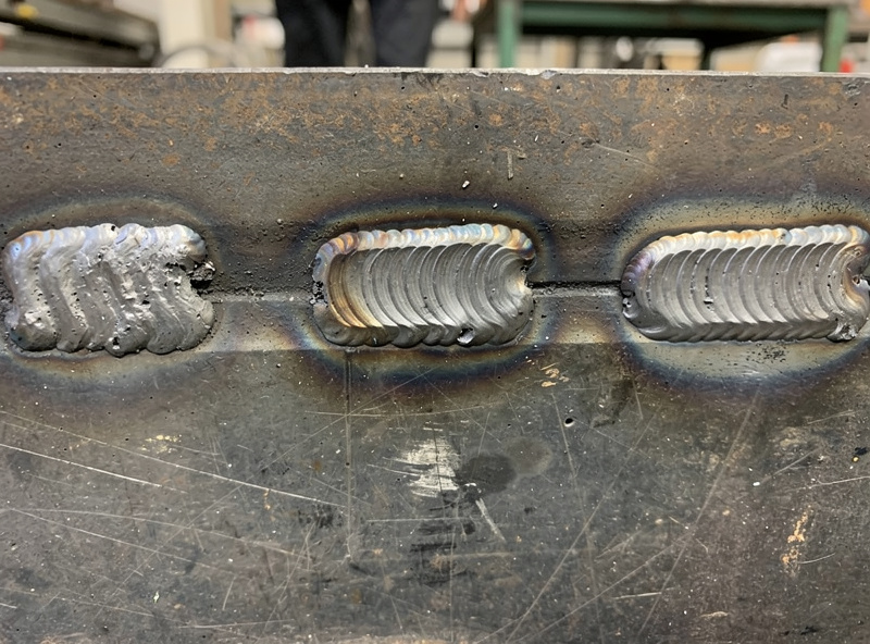 Progression of practice weld beads from uneven beginner bead to smooth consistent bead