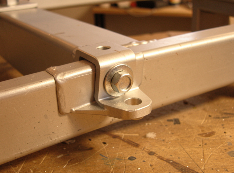 Aluminum bracket bolted to a steel frame with an isolating washer to prevent galvanic corrosion