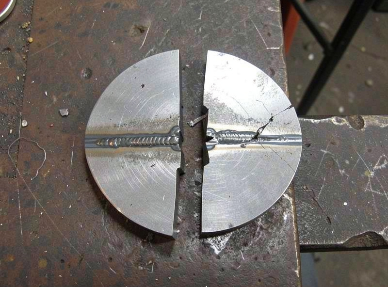 A nick-break coupon snapped in two showing the internal weld cross section