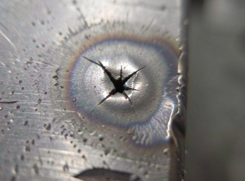 Star-shaped crater crack at the end of a steel weld bead where the arc was broken
