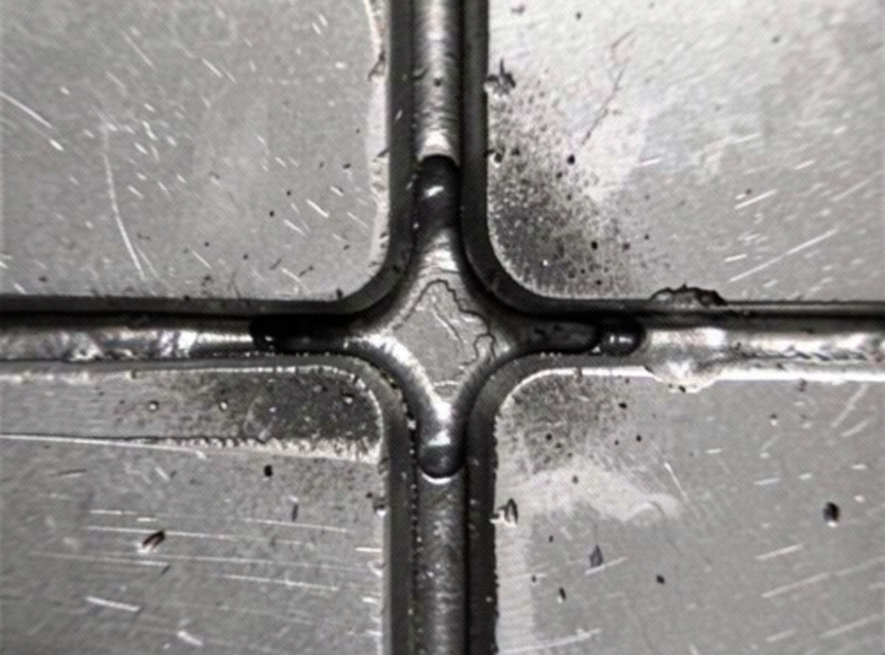 Etched cross section of a steel fillet weld showing incomplete penetration at the root