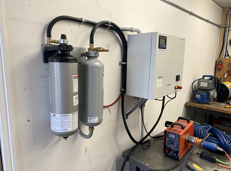 A two-stage air drying setup with coalescing filter, desiccant dryer, and water trap feeding a plasma cutter