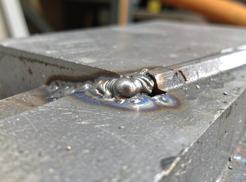 Stick weld bead with slag inclusions and irregular surface, slag partly chipped