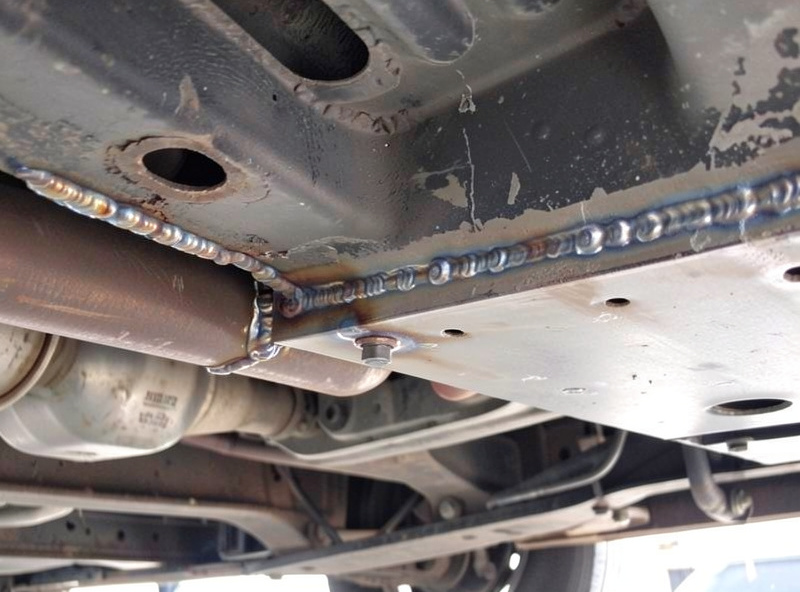 Welding a replacement floor pan into a car with plug welds along the overlap
