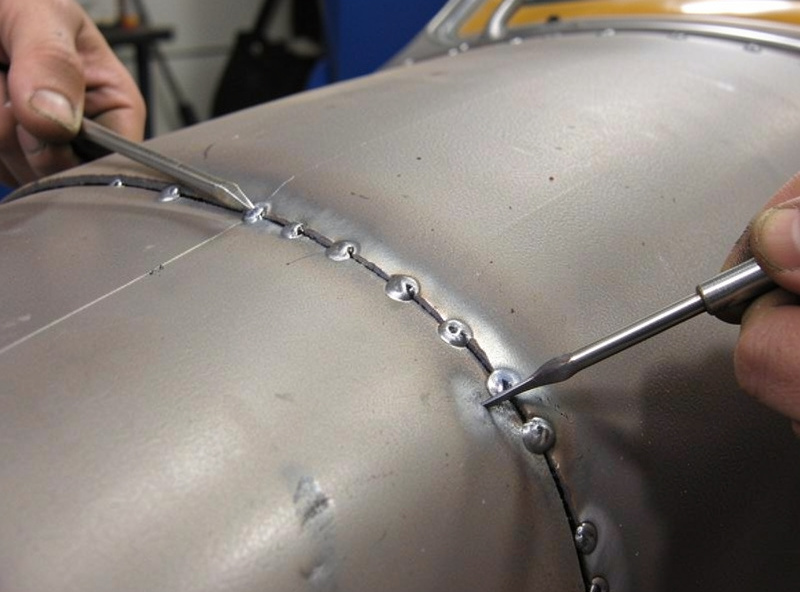 Stitch welding a quarter panel patch with small spaced tack welds to prevent warping