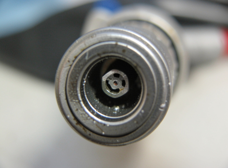 MIG welding gun head with nozzle removed showing contact tip and gas diffuser