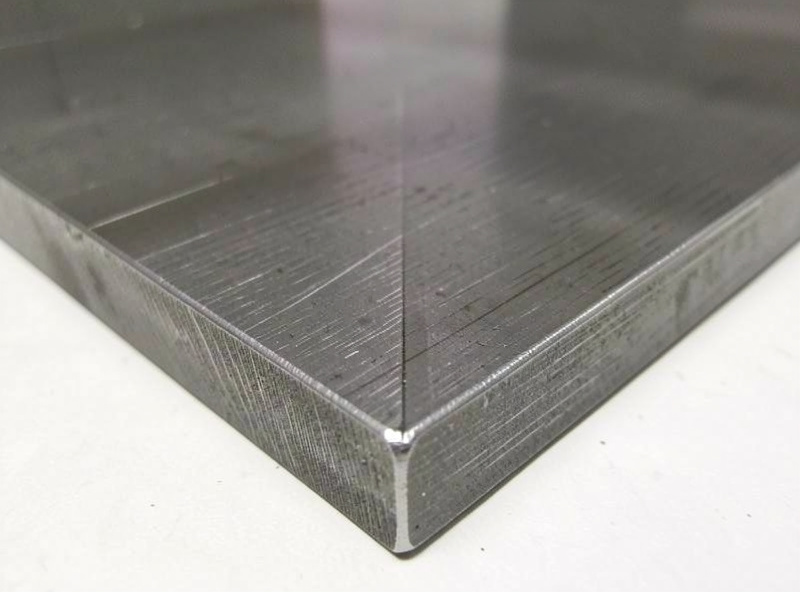 Square clean edge on a piece of thick steel plate freshly cut with an oxy-acetylene torch