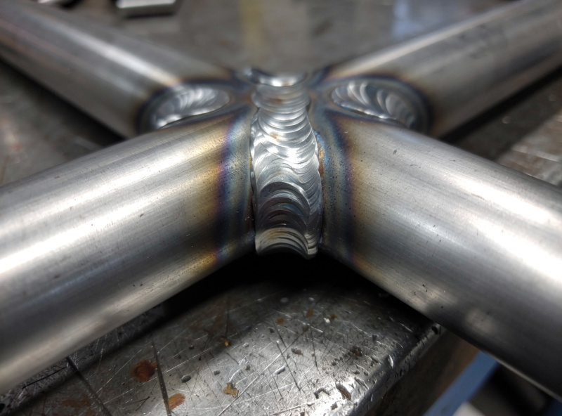 TIG welding a 4130 chromoly tube cluster joint on a roll cage with tight fishmouth notches and a clean fillet