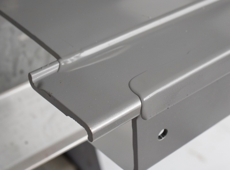 Thin even coat of zinc-rich weld-through primer drying on a clean steel flange