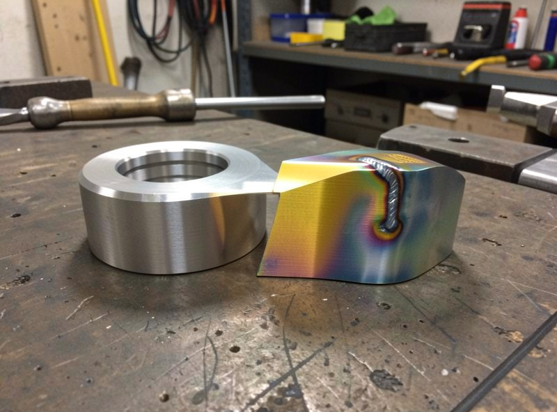 An anodized aluminum part next to a welded joint showing color match after anodizing